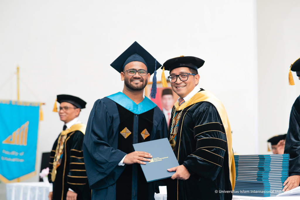 MA in Political Science graduate from India receiving diploma at Universitas Islam Internasional Indonesia commencement ceremony